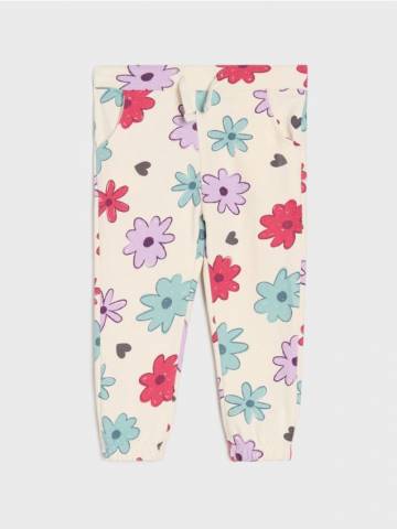Бавовняні штани з квітковим принтом - кремовий