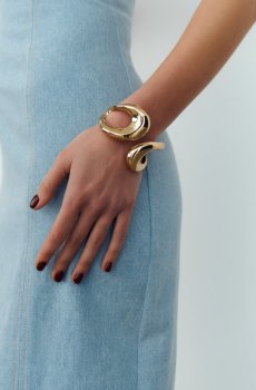 Золотистий браслет асиметрія