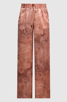 Розовые брюки из шелка в цветочный принт